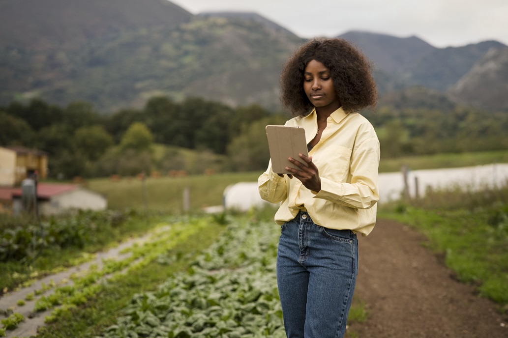 A farmer using a tablet in the field